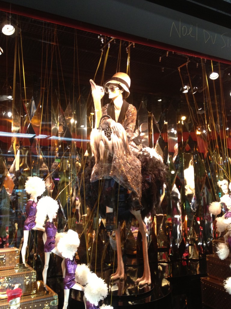 An impeccably stylish mannequin riding a rotating Ostrich